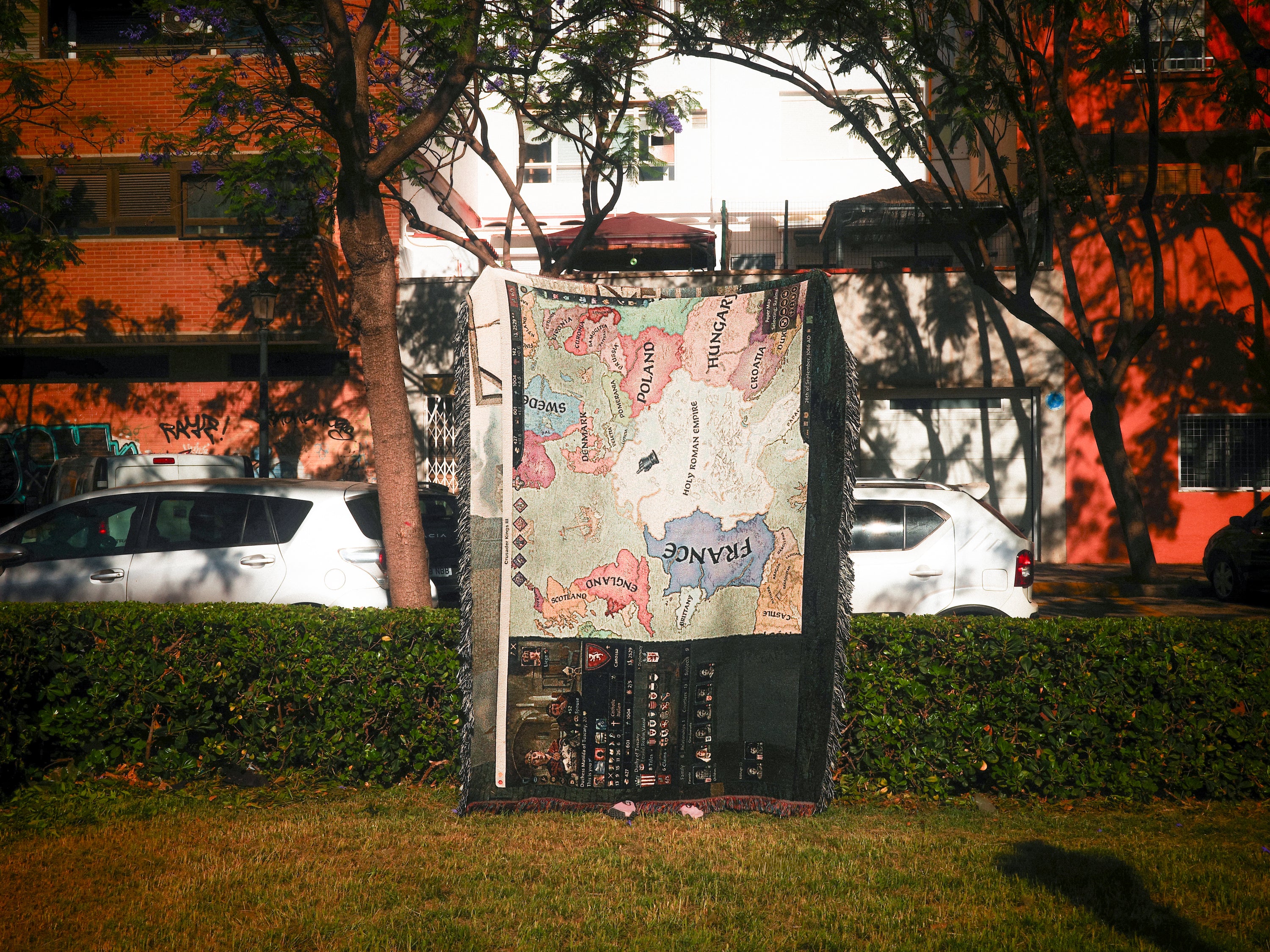Vintage map displayed outdoors with a building and trees in the background
